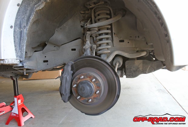 As is the case with any suspension work, start with the right tools  a properly rated jack and jack stands area a must. After finding the proper location to jack up the vehicle, set the jack stand in place and make sure the vehicles weight is safely supported. Then, remove the front tire to gain access to the suspension components.